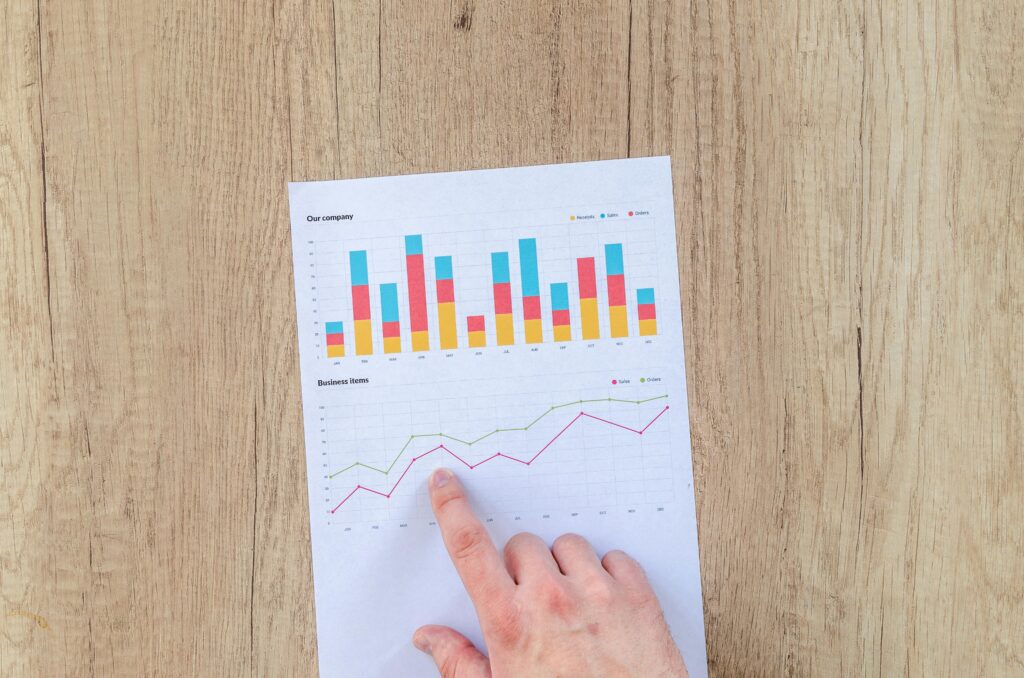 Man pointing at an investment graph on paper.